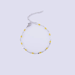 Detailed macro view of silver lip chain with yellow enamel beads and adjustable clasp