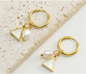 Detailed view of 18K gold geometric earrings with white natural pearls and triangle charms