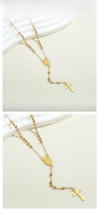Close-up of golden stainless steel rosary necklace with cross pendant and medal