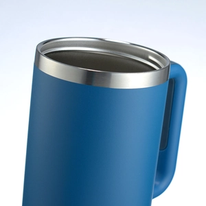 Detailed close-up of blue matte finish stainless steel tumbler rim and ergonomic handle