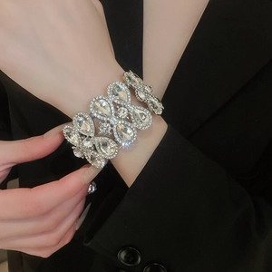 Macro detail of silver geometric bangle featuring teardrop crystals and micro diamonds