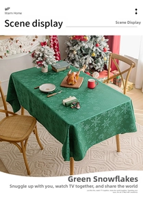 Detail of green Christmas tablecloth with white snowflake patterns in festive setting