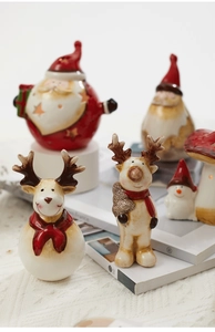Detail of vintage ceramic Santa and Reindeer figurines with warm festive lighting