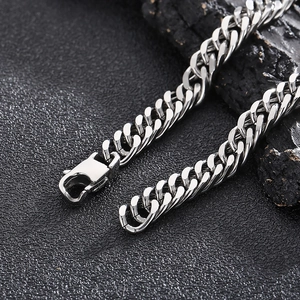 Macro shot of silver curb chain with lobster clasp and high-polish stainless steel surface