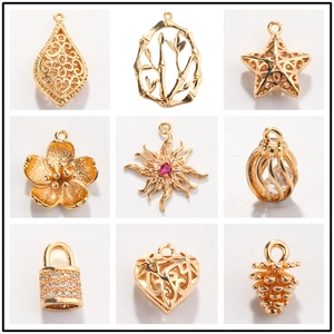 Golden DIY jewelry pendants including heart, star, and flower shapes with red gemstones