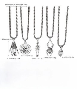 Detailed view of five gothic necklaces featuring spiderweb, skull, and skeletal hand pendants