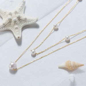 Elegant 925 sterling silver double-layer necklace with baroque pearls on white sea shell background
