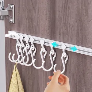 Adjustable sliding rack with white track and S-hooks for kitchen cabinet storage