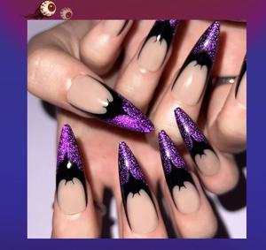 Detail of long stiletto press-on nails with purple glitter and black bat French tip designs