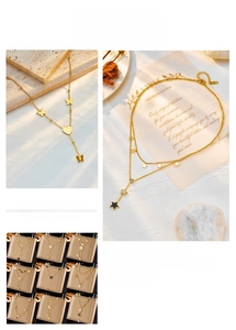 Collection of layered gold titanium steel necklaces with butterfly and heart pendants
