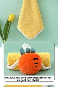 Detail of yellow coral fleece hand towel featuring a cute cartoon doll and wavy edges