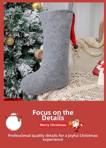Detail of grey felt Christmas stocking with red trim, plush decor and a small black bell