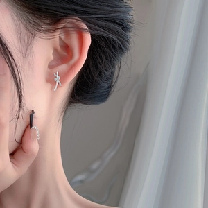 Elegant S999 sterling silver knot earrings with sparkling cubic zirconia on model