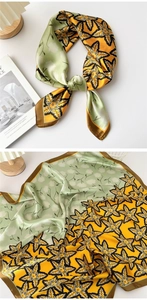 Detail of silk-satin square scarf with maple leaf print in ginger and green tones