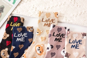 Close-up of five pairs of cotton mid-calf socks with cute animal embroidery and patterns