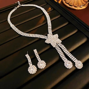 Sparkling crystal star necklace and matching teardrop earrings set on black velvet