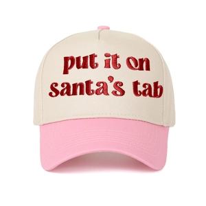 Detail of red embroidered text Put It on Santa's Tab on beige cotton baseball cap