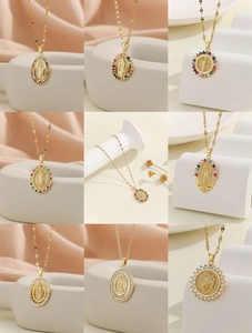 Detailed close-up of Virgin Mary and lion pendants with colorful cubic zirconia stones