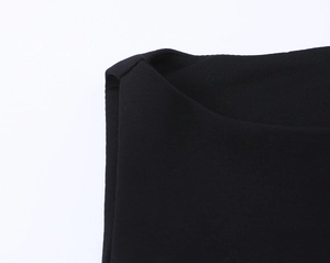 Macro view of black sleeveless dress fabric texture with high quality knit detail