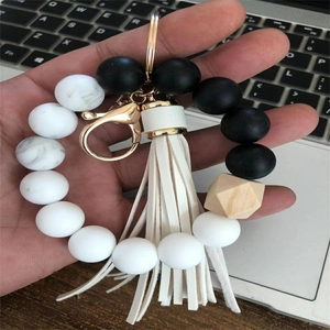 Silicone wristlet keychain featuring black agate beads, wooden bead and leather tassel