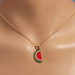 Detailed view of a gold titanium steel necklace with a colorful watermelon pendant on a model