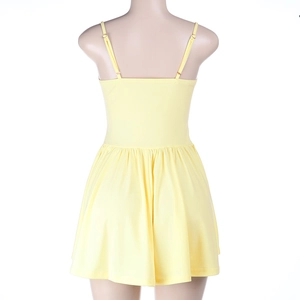 Detail of adjustable thin straps and pleated back on a pale yellow mini dress