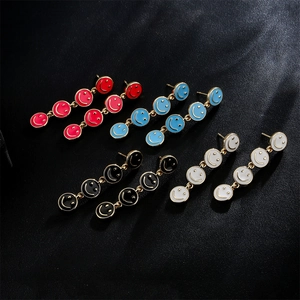 Golden drop earrings with four colorful enamel smile faces in red blue black and white