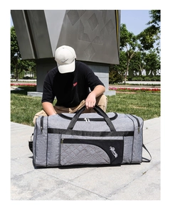 Close-up of grey oxford travel bag with reinforced straps and sports embroidery