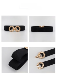 Detail view of black elastic wide waist belt for women with interlocking gold buckle closure