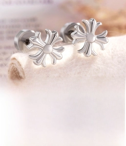 Macro detail of silver cross earrings showing 0.8mm titanium steel screw post texture