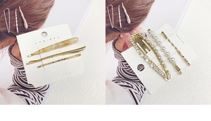 Detail of elegant pearl and rhinestone hair clip sets on display card with gold finish