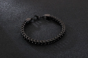 Detail of black stainless steel wheat chain bracelet with a secure lobster clasp