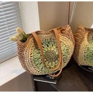 Detail of colorful paper rope hand-woven straw tote bag with round floral sunburst pattern