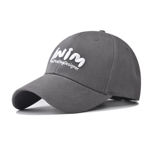 Close-up of dark grey washed cotton baseball cap with white 3D embroidery detail