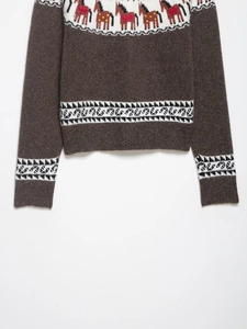 Detailed view of the Fair Isle knit sweater featuring horse patterns and wool texture