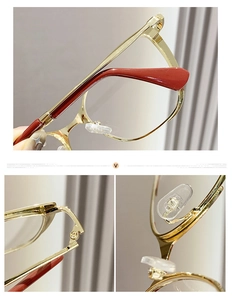 Detail of red and gold metal eyeglass frame showing hinges and silicone nose pads