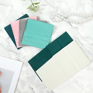 Premium microfiber jewelry pouches in various colors displayed on white marble surface