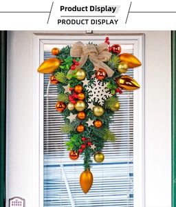 Detailed teardrop Christmas wreath with gold baubles, red berries and a burlap bow