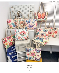 Detail view of canvas tote bags with colorful butterfly prints and durable straps