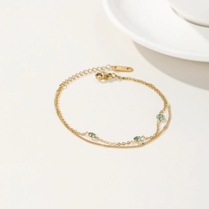 Bracciale a doppio strato in acciaio inossidabile dorato con tre zirconi blu