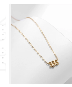 Detail of gold S925 silver necklace with 333 lucky number pendant and zircon stone