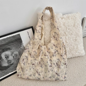 Detail of beige tote bag with purple butterfly print and vertical lace拼接 edge