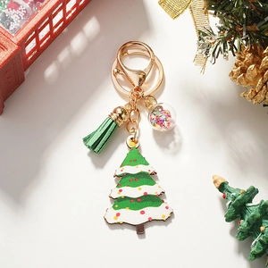 Detailed view of Christmas tree keychain with green leather tassel and glitter glass ball