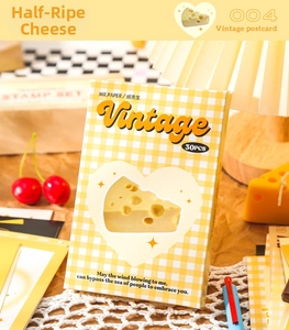 Detail of vintage postcard box with yellow checkered pattern and heart-shaped cutout design