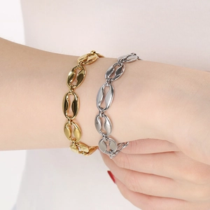 Detail of coffee bean link bracelets in gold and silver finish with lobster clasp