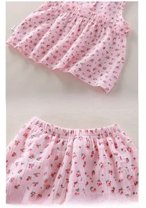 Detail of baby girl floral cotton pajama set with elastic waist and ruffled hem