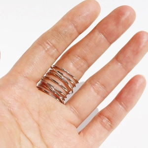 Modern irregular multi-layer silver spiral spring wide ring shown on a hand model
