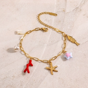 Close-up of golden stainless steel bracelet with coral, pearl, and starfish charms
