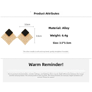 Detailed view of woven metal geometric earrings with black square center and silver pins