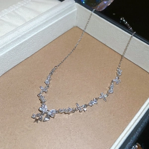 Macro shot of sparkling bow pendant necklace with stars in a jewelry gift box